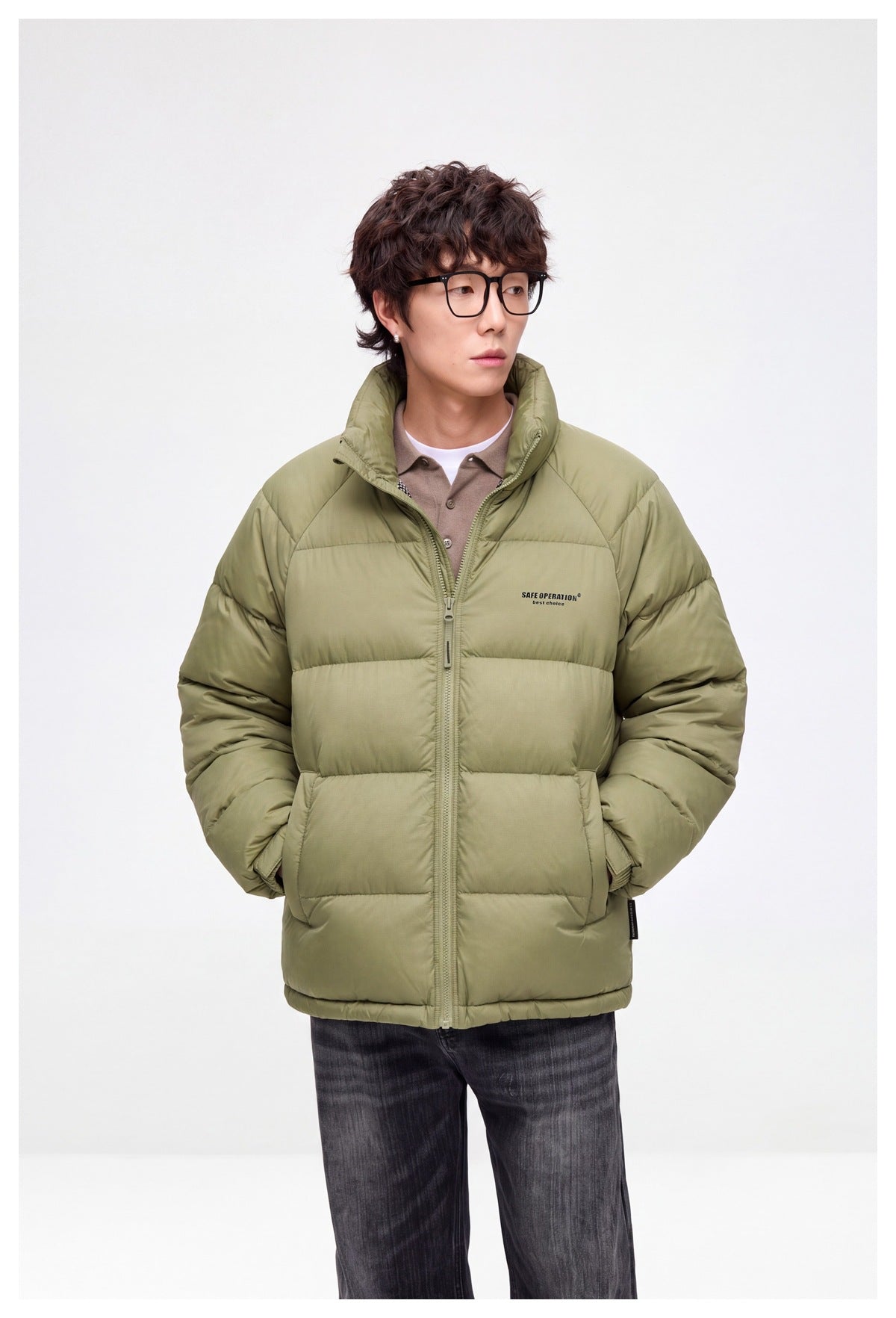 Front view of a model in a light olive quilted puffer jacket with a high collar and full-length zip.