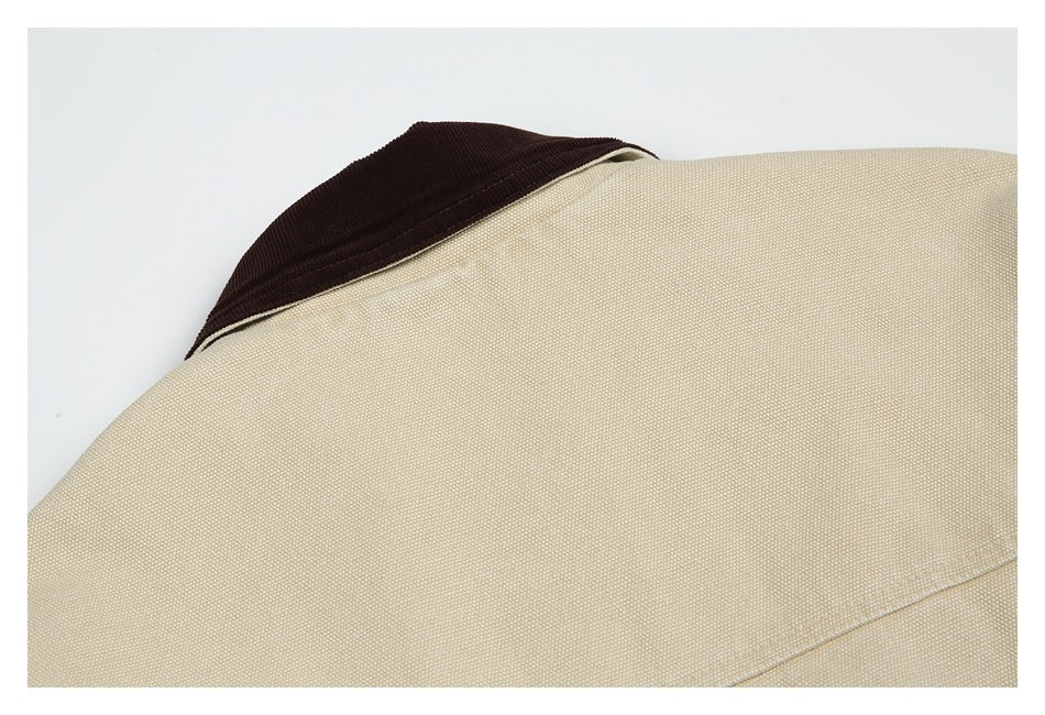 Close-up of a beige jacket collar with a dark brown ribbed collar insert.