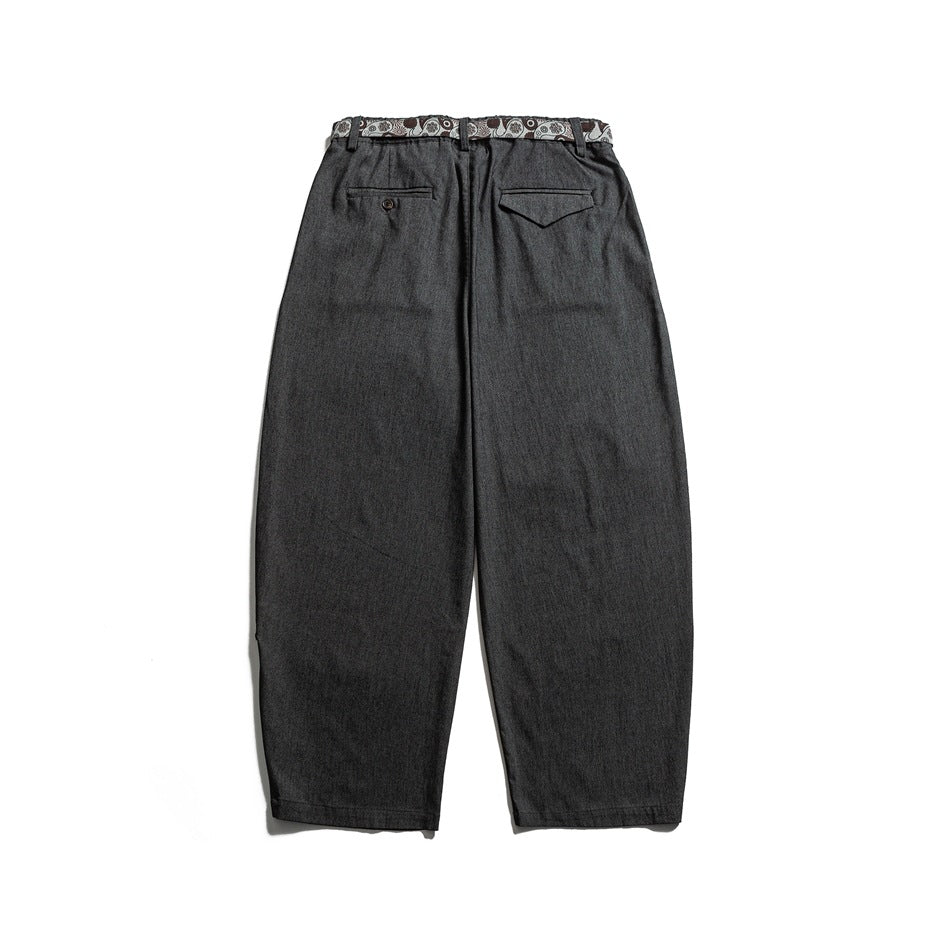 Back view of charcoal trousers with two welt pockets and a patterned strip along the waistband.