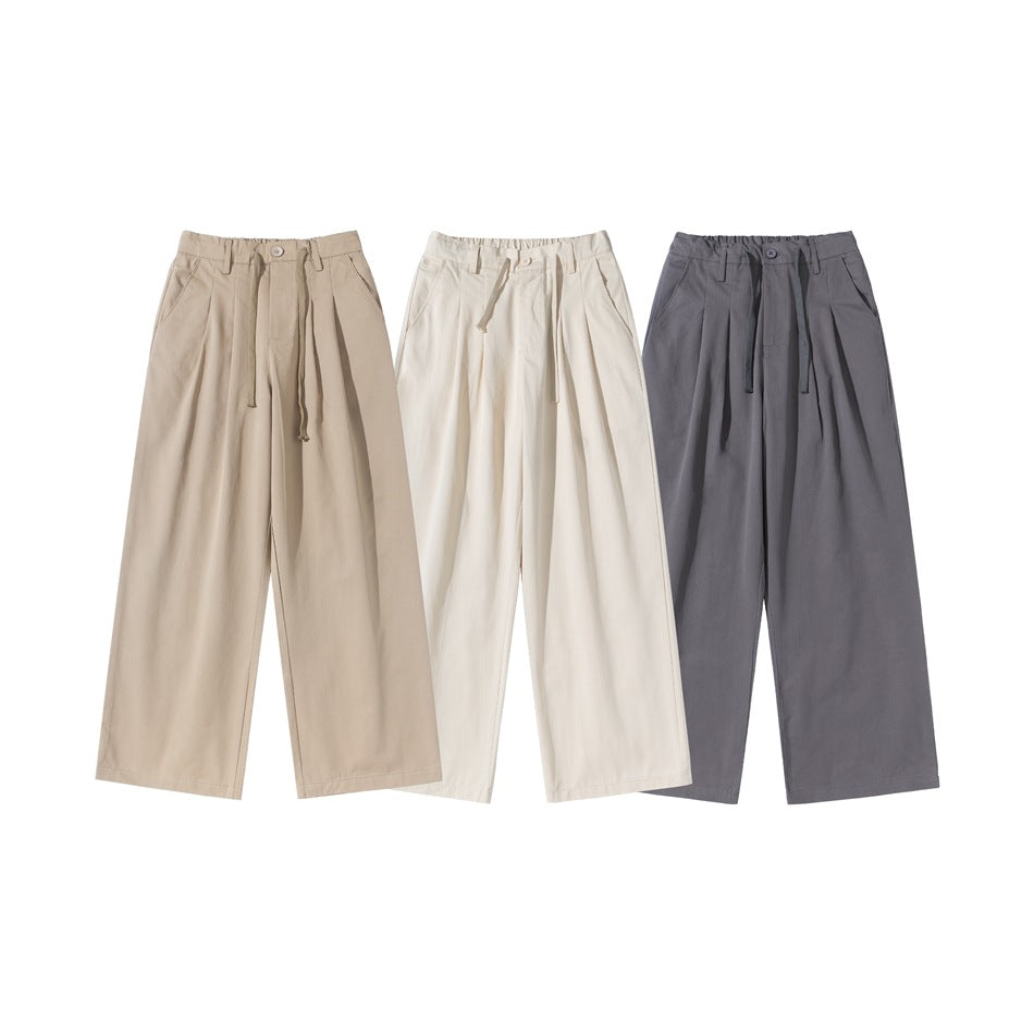 Three pairs of wide-leg trousers shown from the front in taupe, ivory, and charcoal gray.