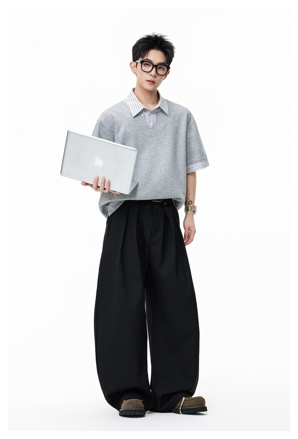 Full-length model wearing a light gray oversized layered top with pinstriped collar and cuffs, and wide black pinstriped