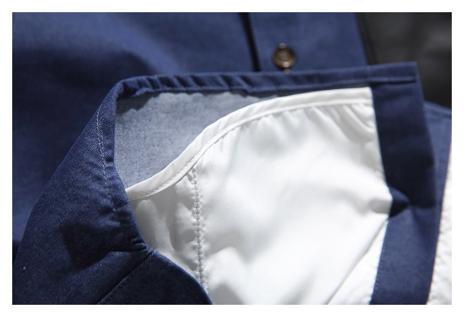 Close-up of the navy garment opened to show its pale inner lining and stitched seams.