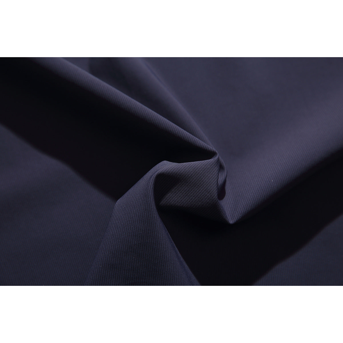 Close-up of dark navy fabric draped to show its fine texture.