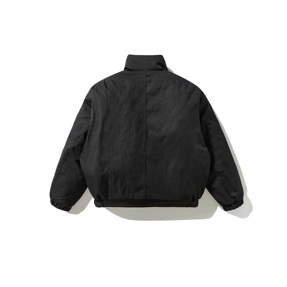 Back view of a black cropped jacket with a stand collar, long sleeves, and gathered cuffs and hem.