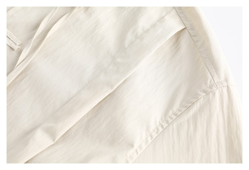 Close-up of the cream shirt's shoulder seam and sleeve construction.