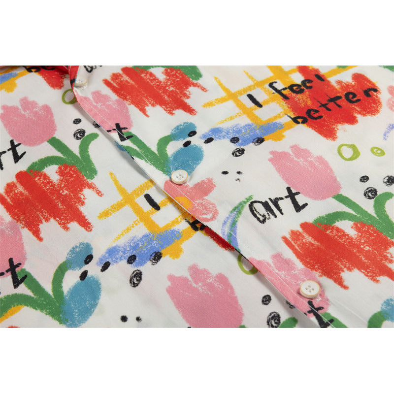 Close-up of the shirt's button placket and colorful abstract print with black English lettering.