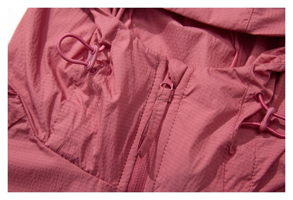 Close-up of the jacket's front zipper and cord adjusters beside the hood opening.