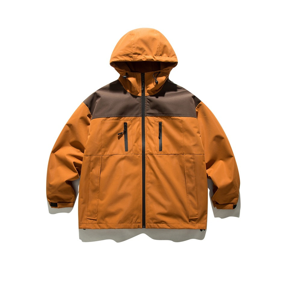 Orange hooded full-zip jacket with brown shoulder yoke, chest zip pockets and lower front pockets, flat lay