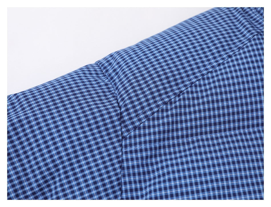 Close-up of blue checked jacket fabric and a diagonal shoulder seam.