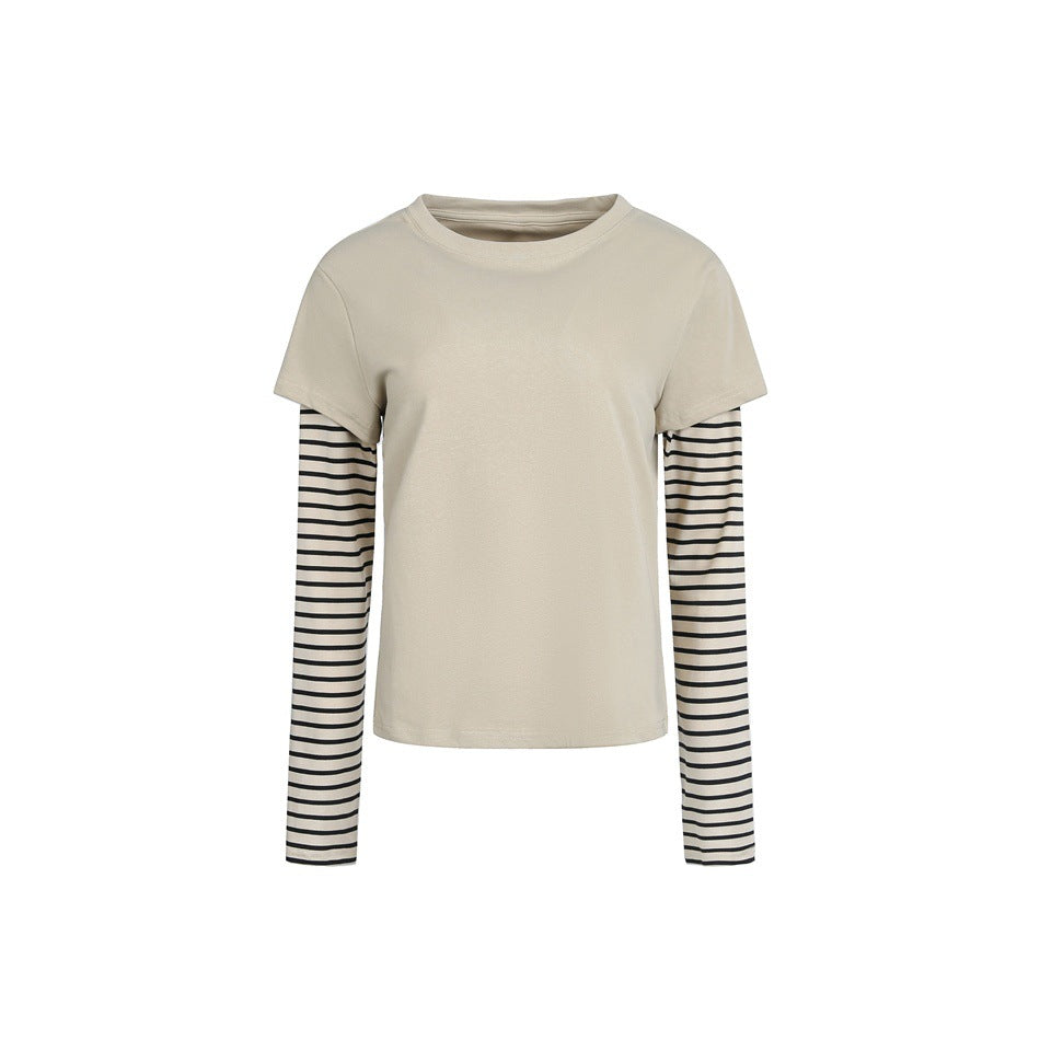 Apricot layered faux two-piece top with solid short-sleeve body and black and cream striped long sleeves, flat front view