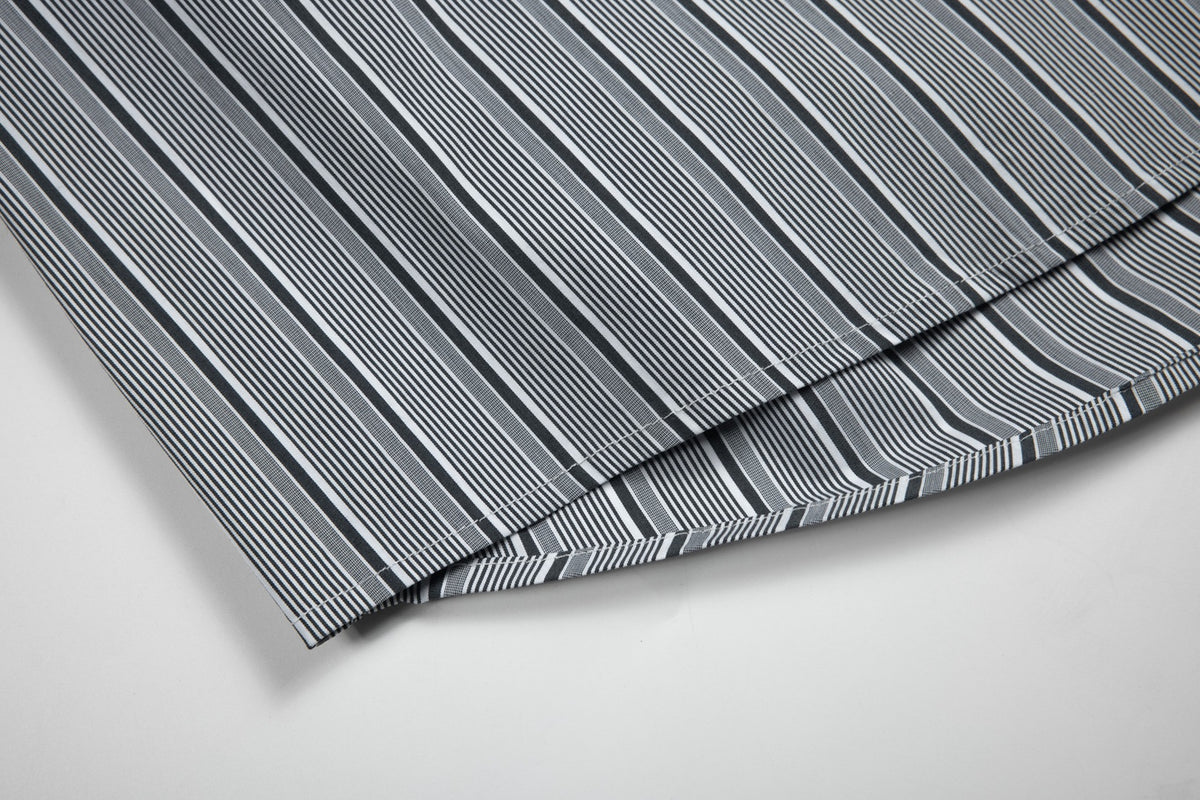 Close-up of the gray-and-white striped shirt fabric and stitched hem.