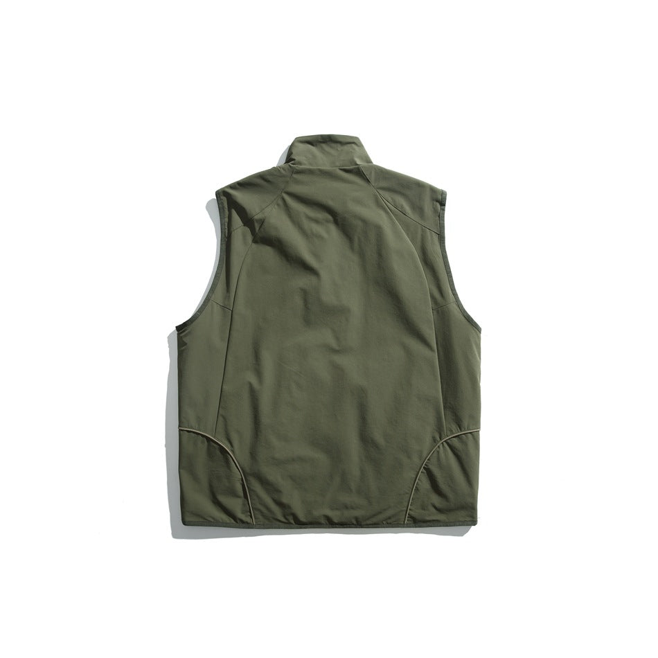 Back view of an olive sleeveless vest with a stand collar and curved piping near the hem.