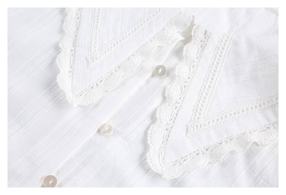 White shirt front close-up showing a lace-trimmed collar, stitched stripes, and buttons.