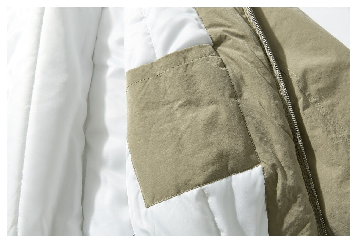 Close-up inside the khaki jacket, showing its white quilted lining, inner pocket, and zipper.