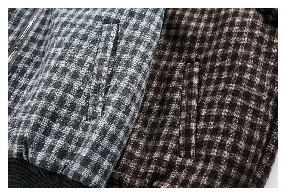 Close-up of gray and brown plaid jackets showing their front pockets and black ribbed hems.