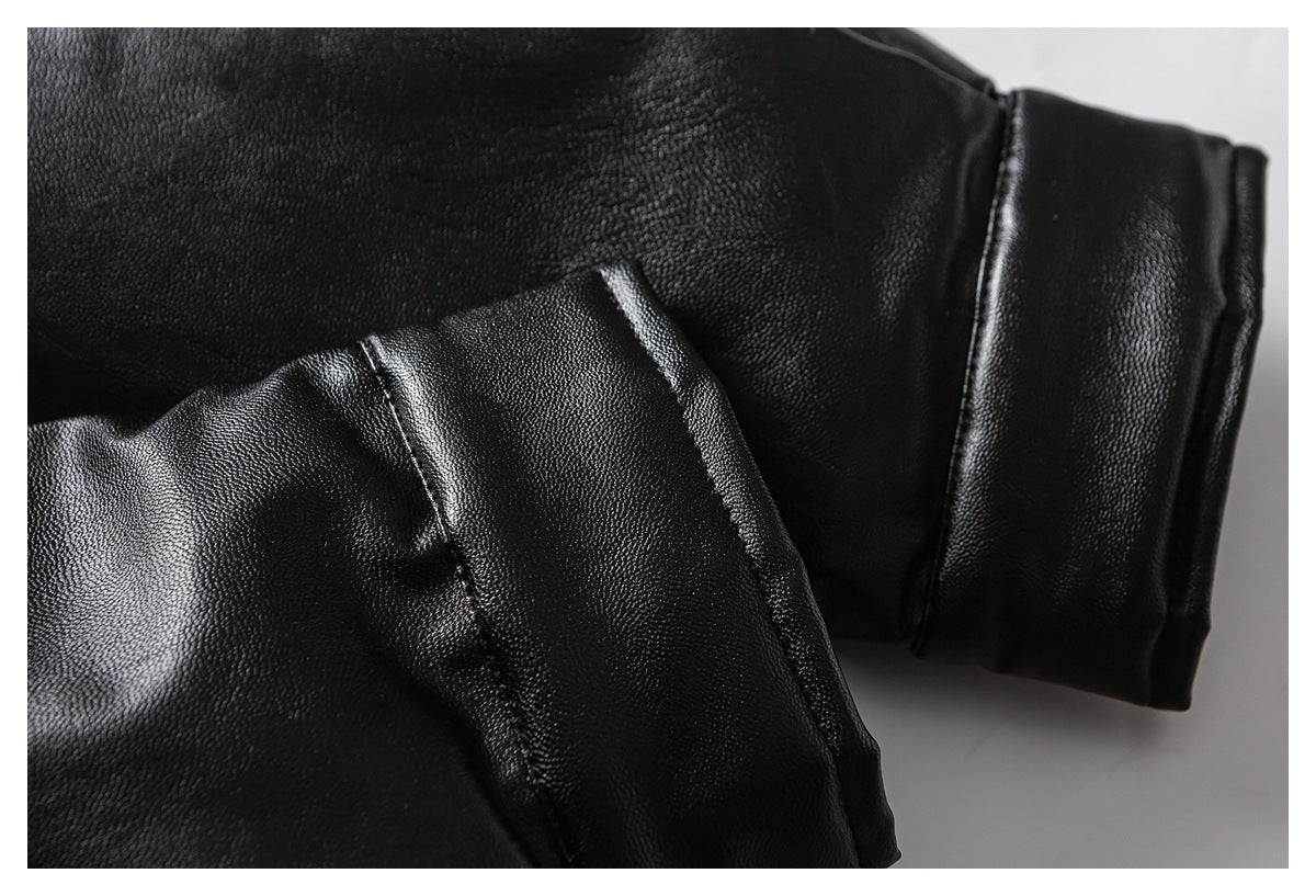 Close-up of a black garment sleeve cuff and stitched panel.