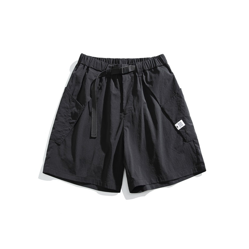 Black knee-length shorts with elastic waist, black buckle belt and large side patch pockets, flat lay