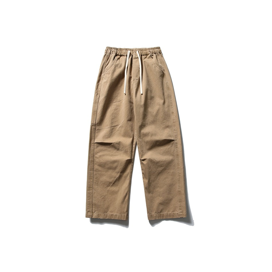 Khaki straight-leg pants with elastic drawstring waist and slanted front pockets, flat front view