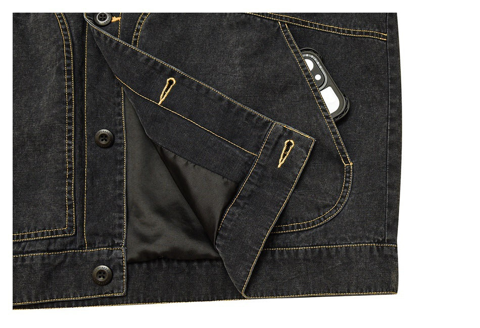 Charcoal denim jacket detail showing a pocket with a phone, an open front and dark lining.