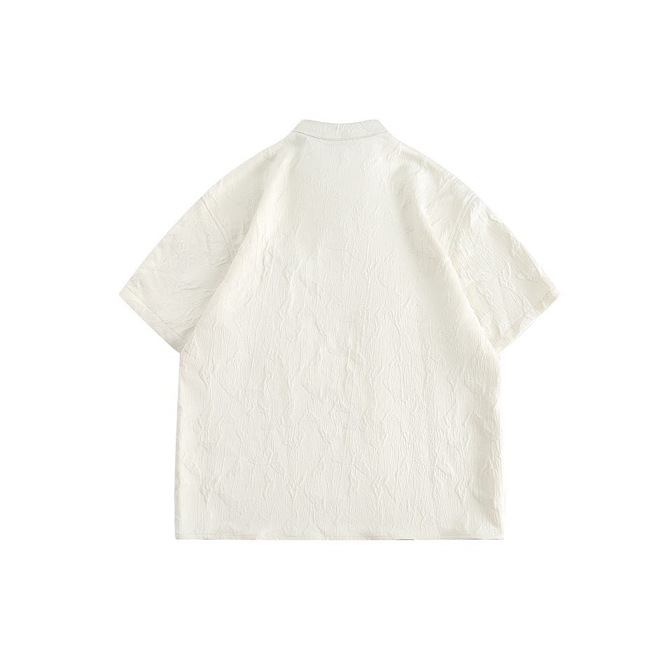 Back view of an ivory short-sleeve jacket with a stand collar and subtle raised pattern, laid flat.