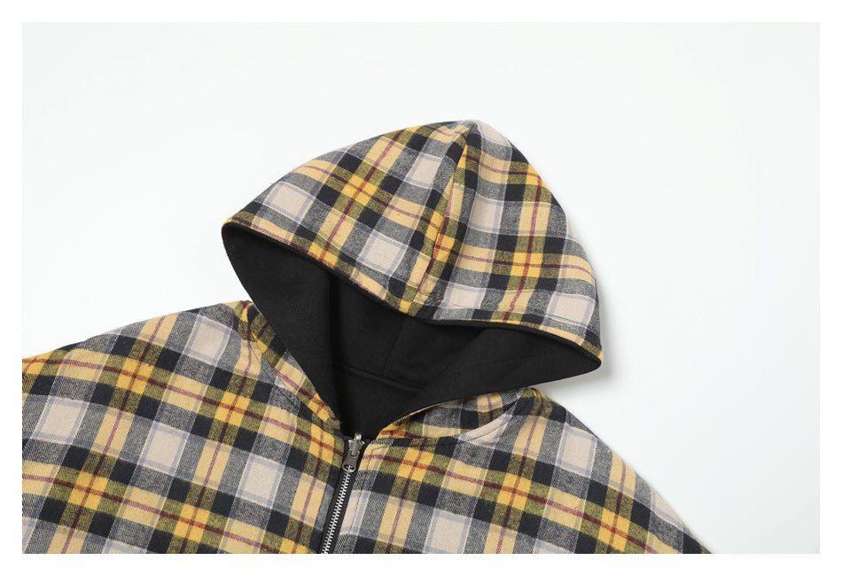 Close-up of the plaid hood, black lining, and upper front zipper of the jacket.