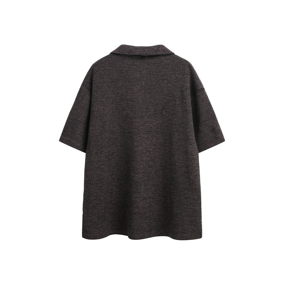 Back view of a dark brown short-sleeve textured polo with a folded collar, shown flat on white.
