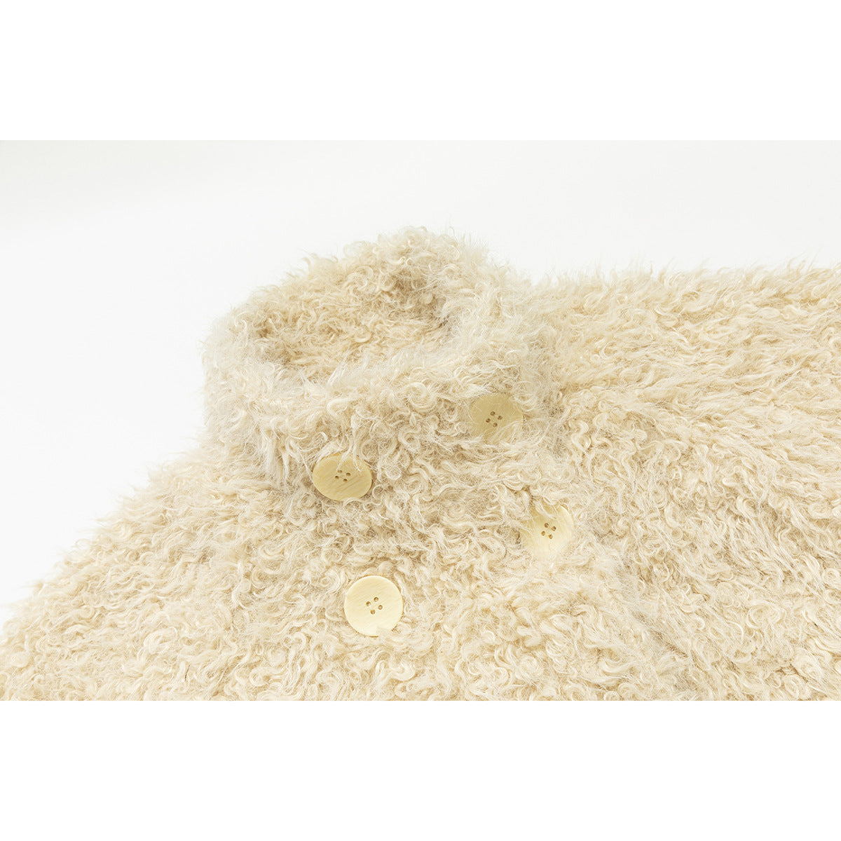 Close-up of the cream jacket’s shaggy collar and front buttons.