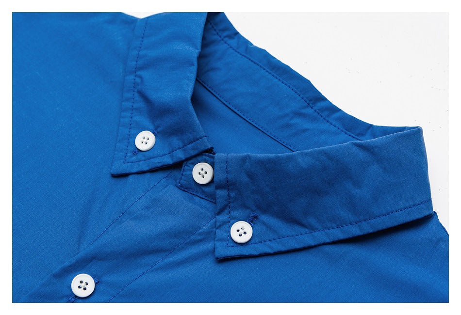 Close-up of a bright blue shirt collar and button placket with white buttons.