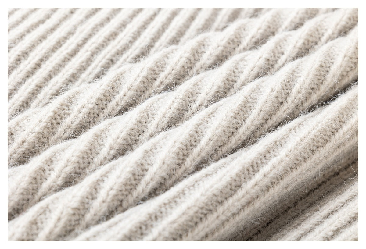 Macro view of the raised ribbed texture of ivory knit fabric.