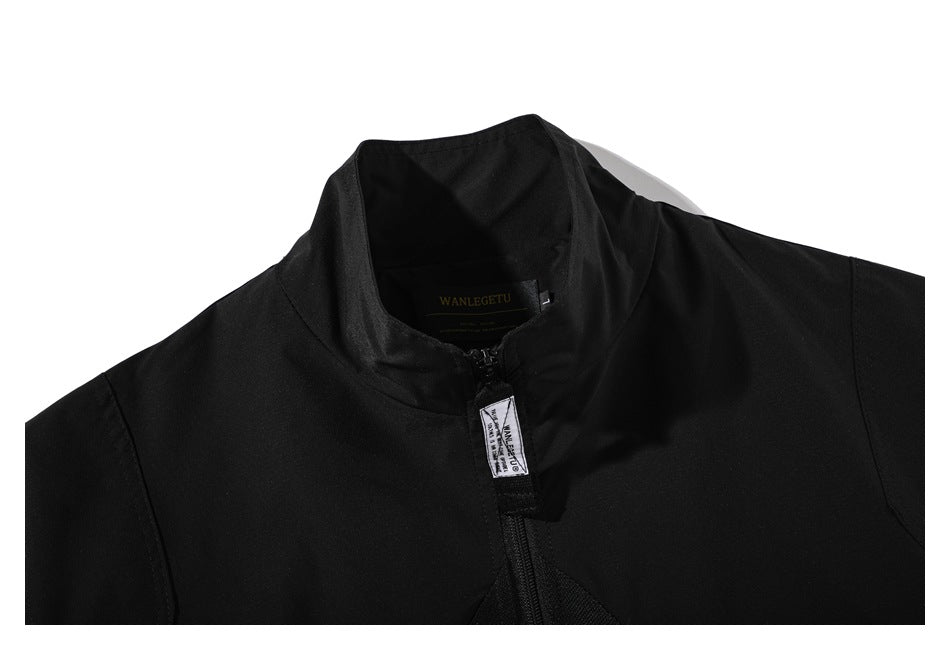 Close-up of the black jacket's raised collar, zipper, and small fabric tab at the neckline.