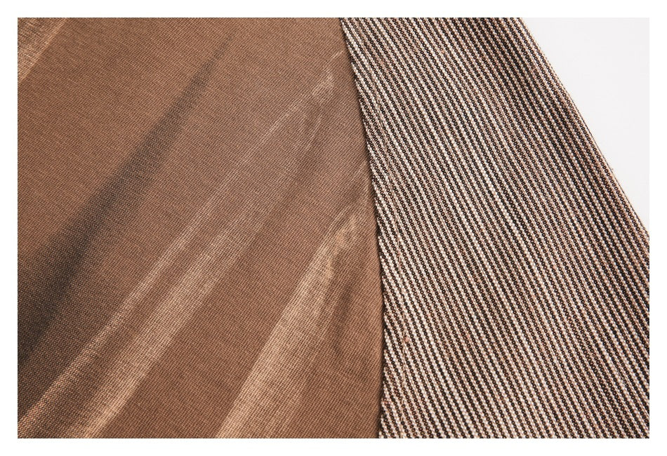 Close-up of a brown garment beside a contrasting black-and-cream tiny geometric patterned panel.