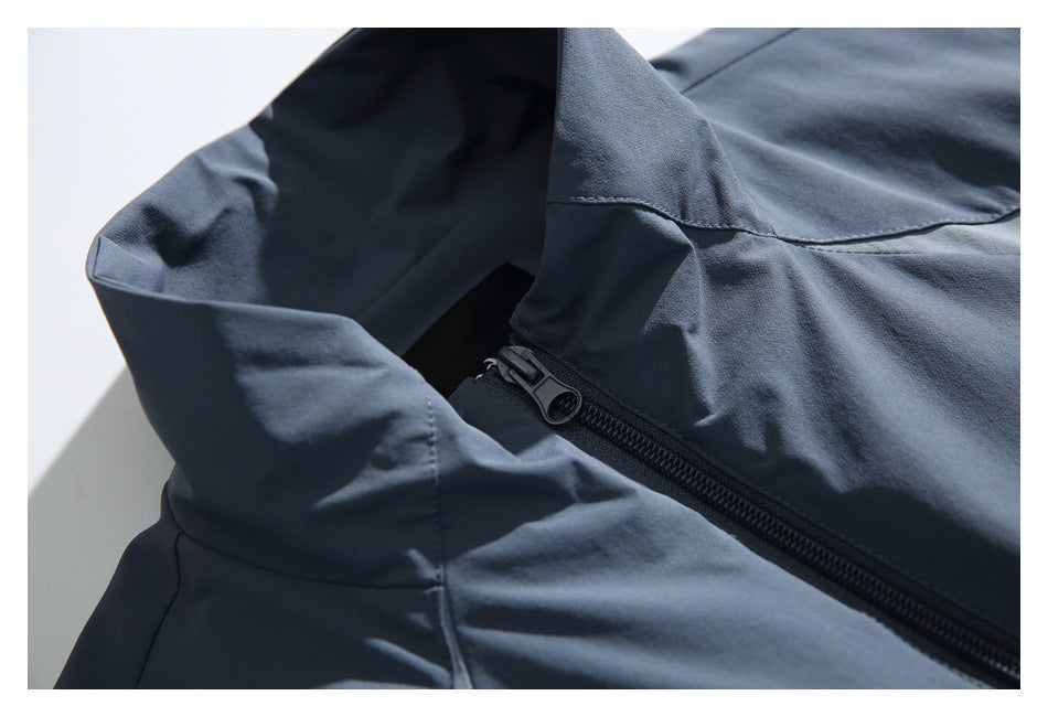 Close-up of a dark zipper and stitched panels on a slate blue-gray garment.