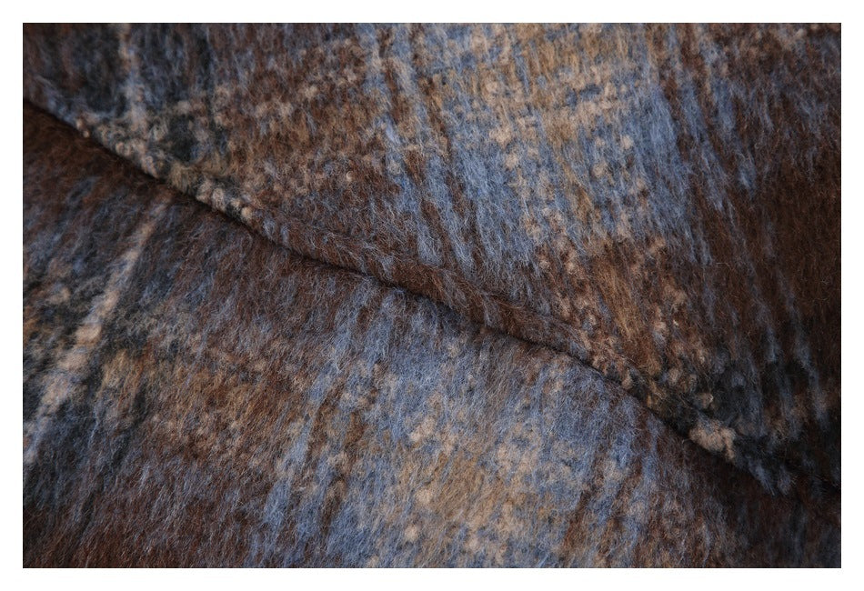 Close-up of fuzzy mottled brown, slate blue, and tan fabric with a diagonal fold.