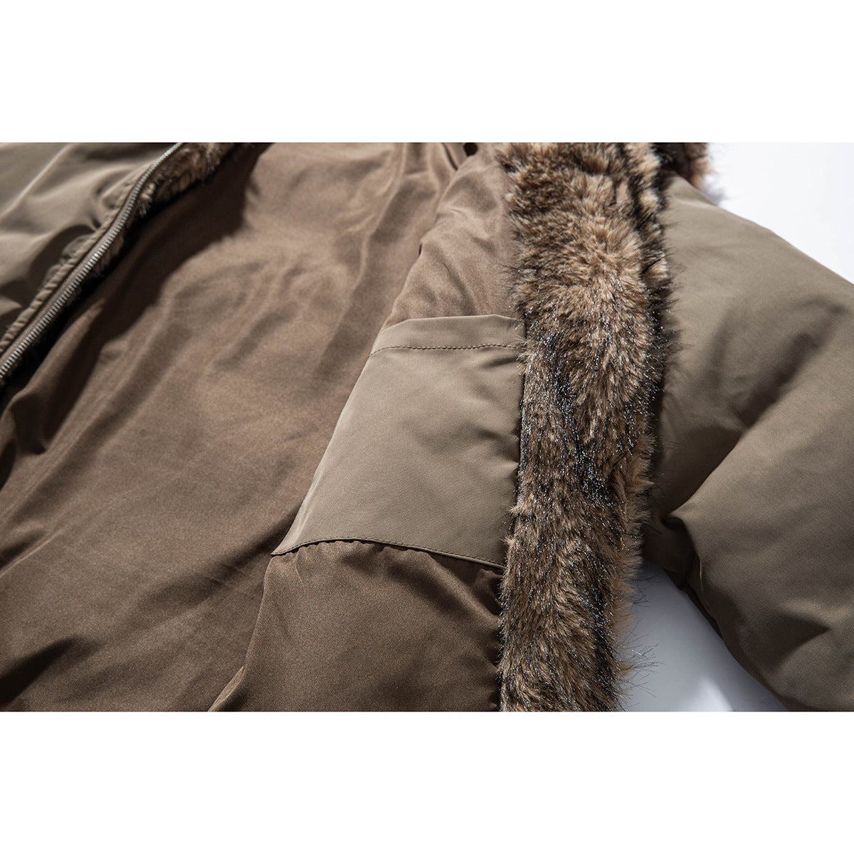 Close-up of a taupe jacket interior with a pocket and a strip of brown faux-fur trim.
