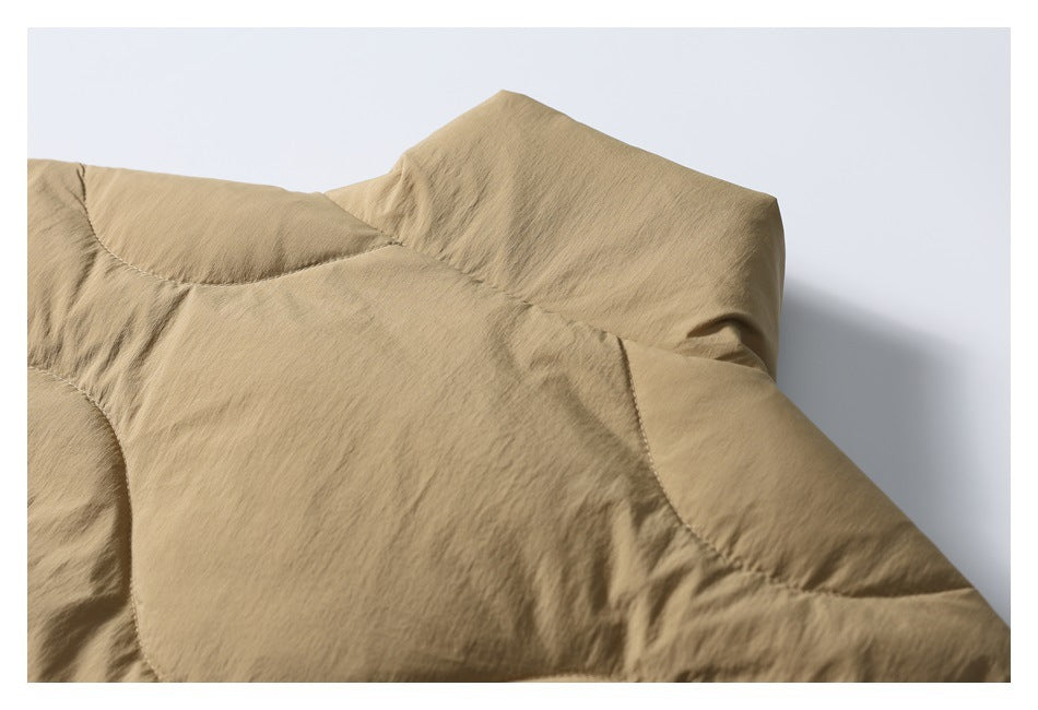 Close-up of the tan jacket's padded shoulder and collar area with curved seams.