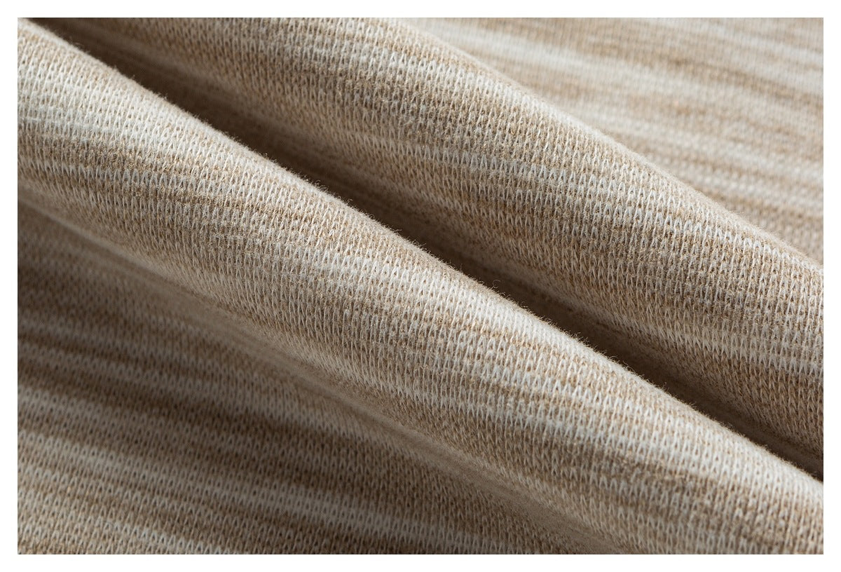 Macro view of beige heathered knit fabric draped in soft folds.