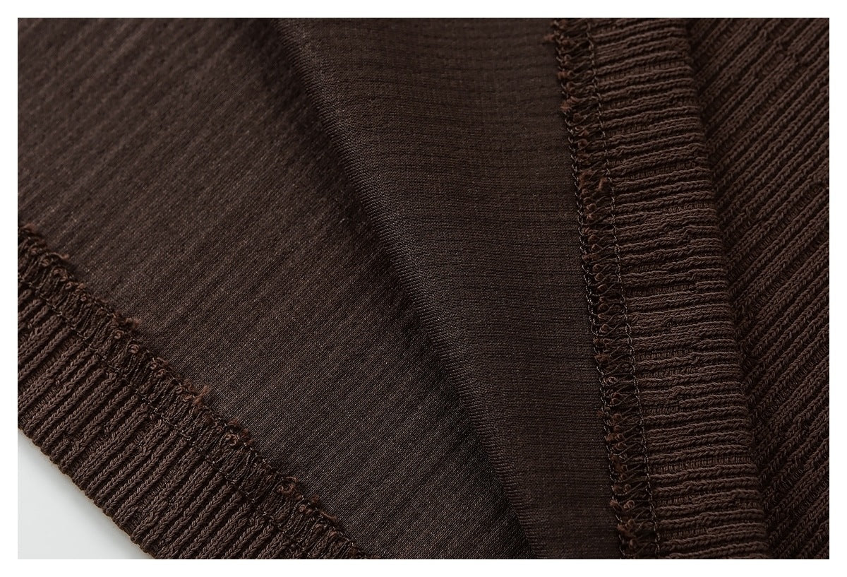Close-up of the brown garment's interior fabric and overlocked seam finishing.