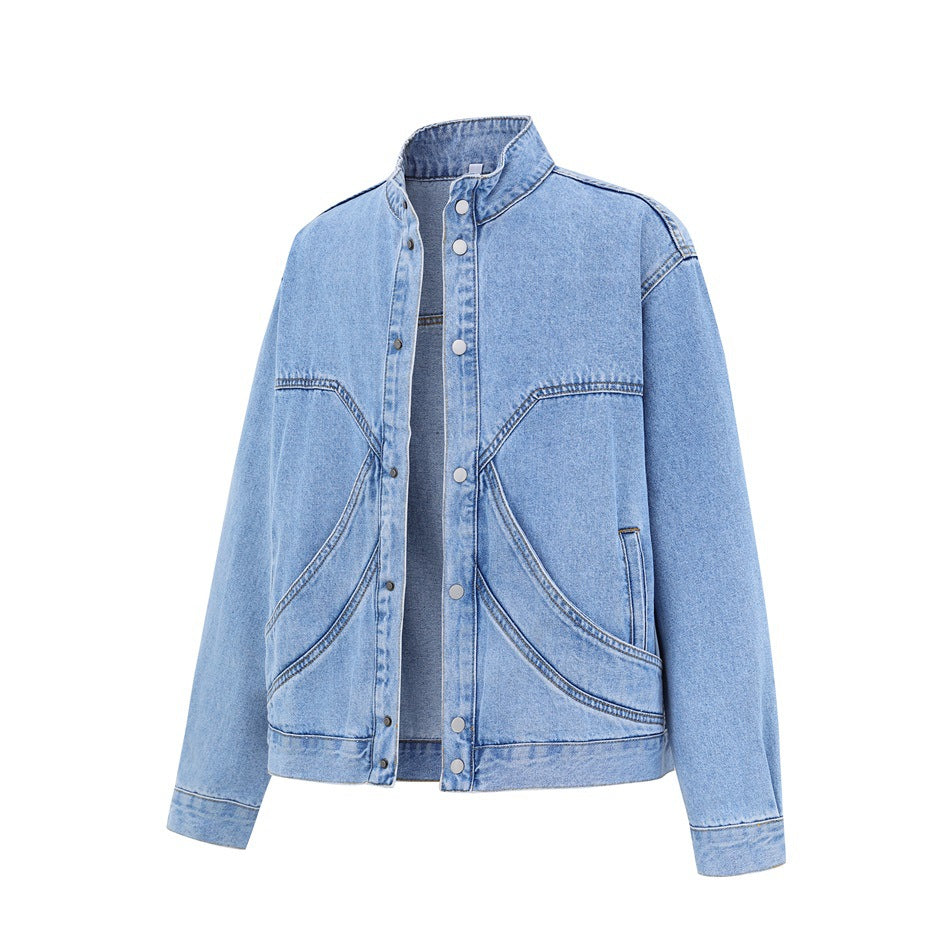 Light blue washed denim jacket with stand collar, snap buttons and curved seam panels, shown flat from a three-quarter front