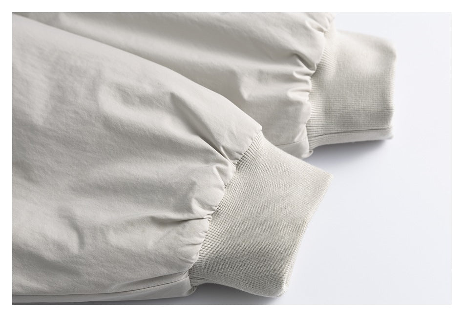 Close-up of pale gray sleeves ending in wide rib-knit cuffs.