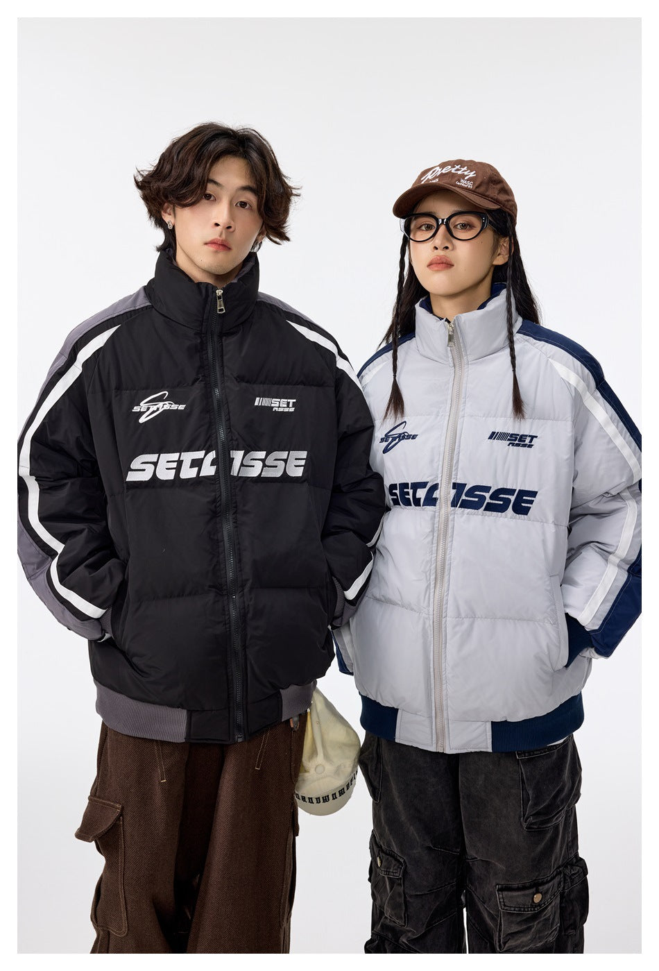 Two models show black and light gray padded zip jackets with contrasting sleeve panels and white stripes.
