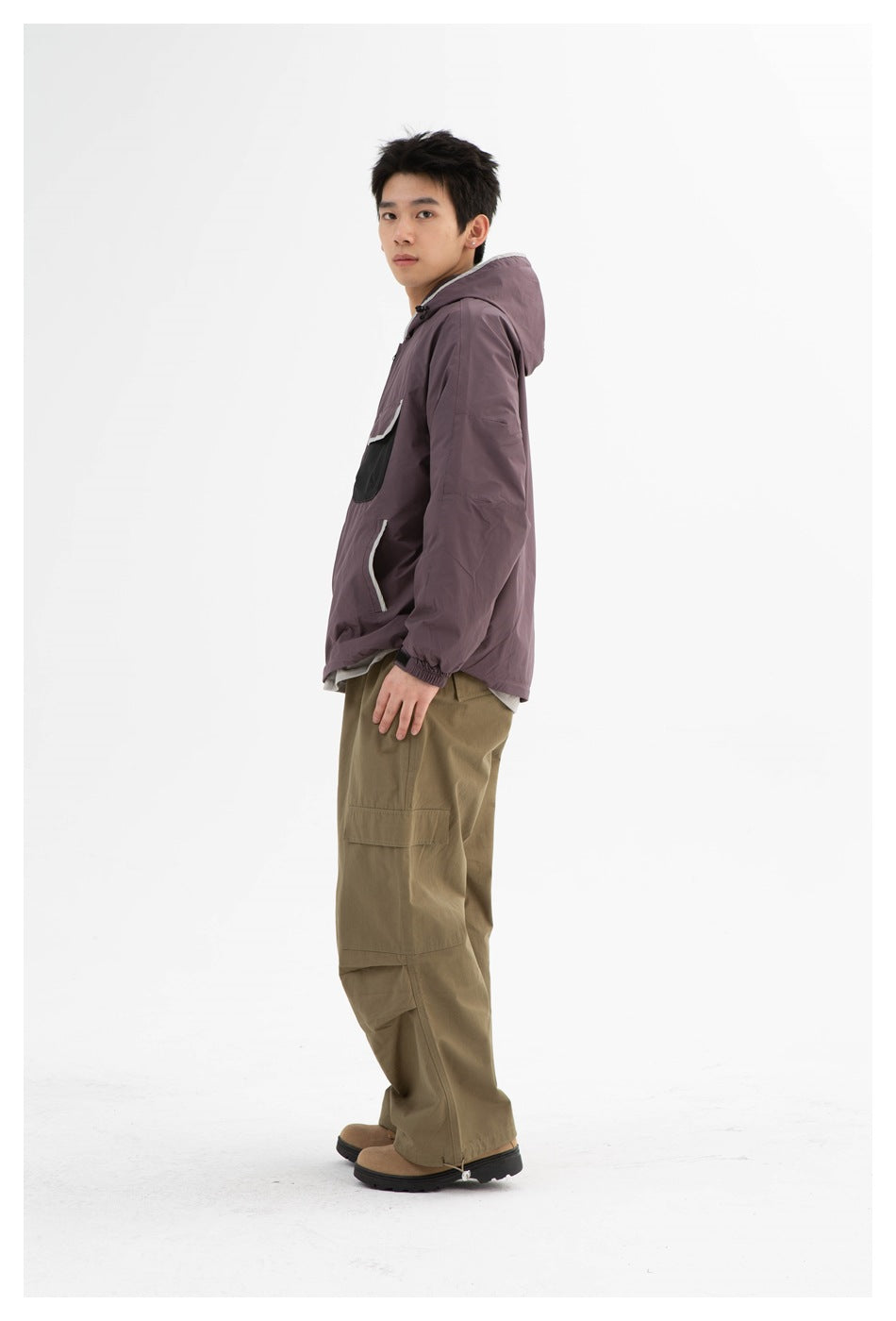 Side view of model wearing the dusty purple hooded jacket with olive cargo pants