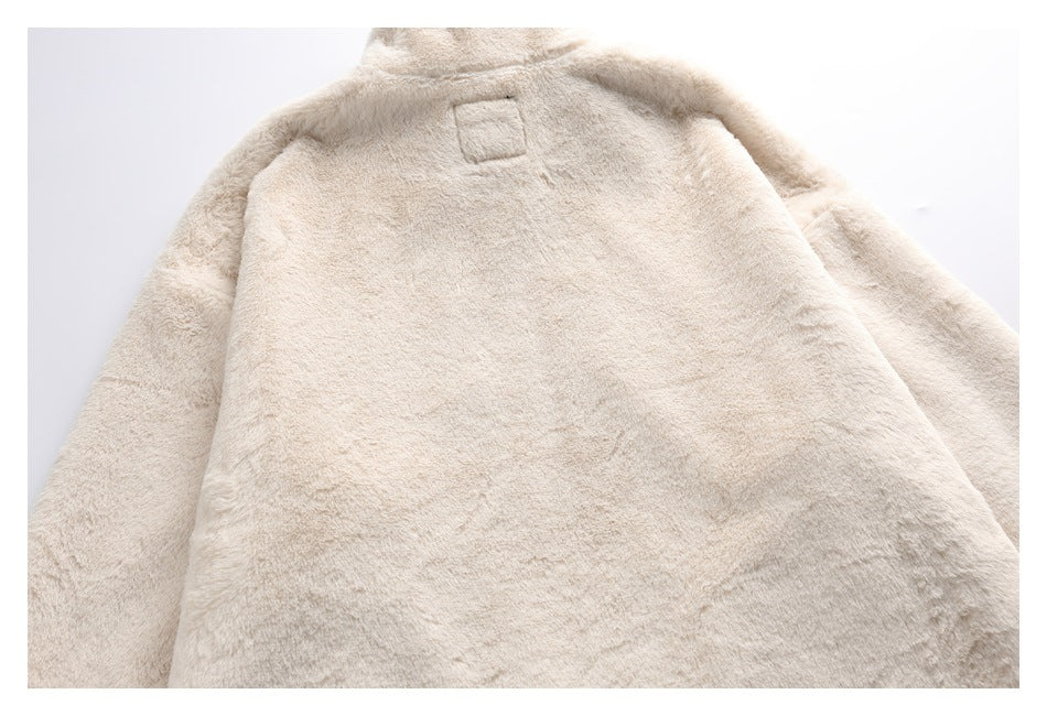 Back view of a cream plush coat laid flat, showing its collar and sleeves.