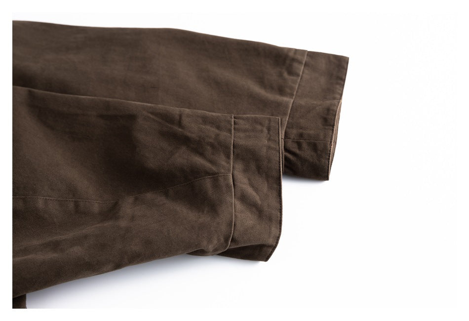 Close-up of a dark brown jacket sleeve and wide cuff with visible seam details.