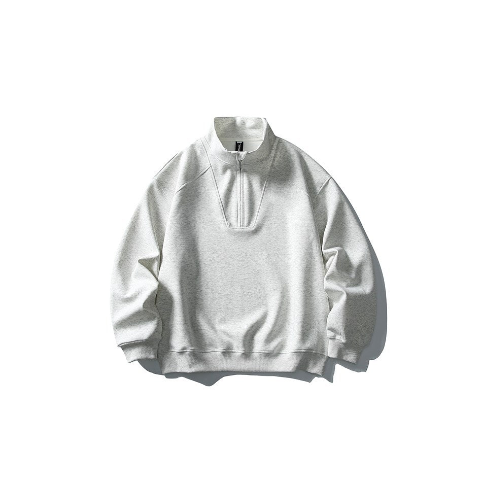 Heather gray half-zip stand-collar sweatshirt with seam details and ribbed cuffs, flat lay front view