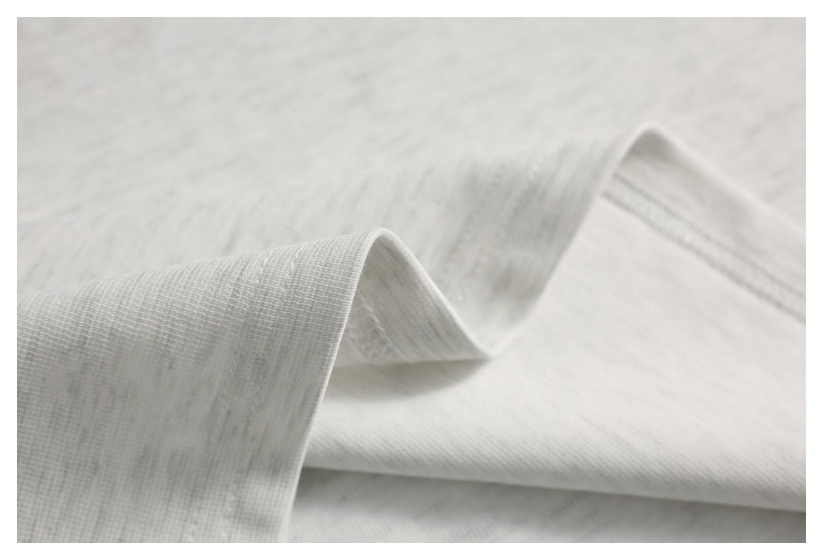 Close-up showing the fine texture and drape of light gray fabric.