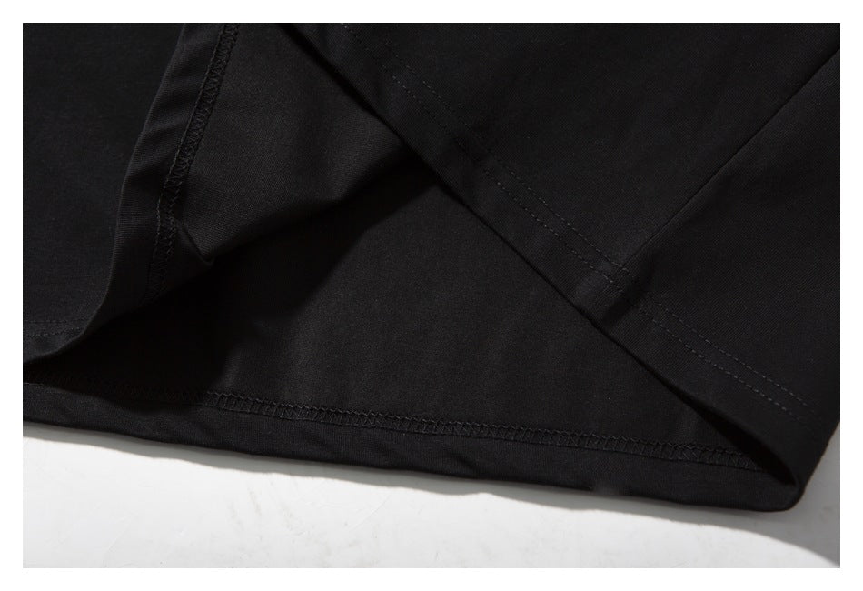 Close-up of black garment fabric and stitched seam construction.