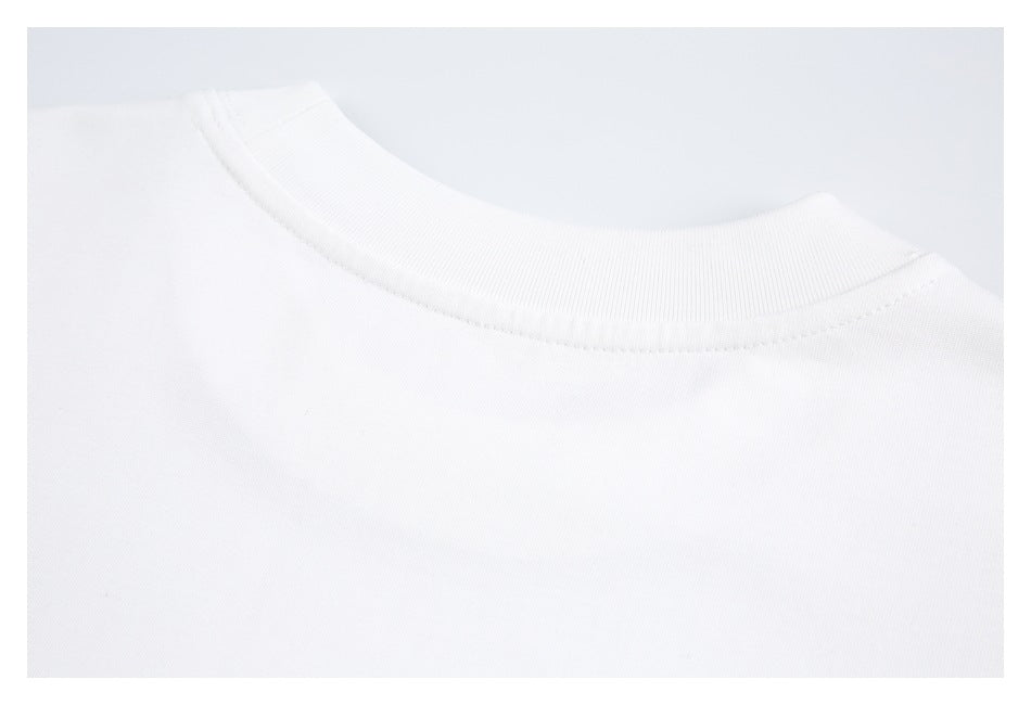 Close-up of a white crew-neck shirt showing the collar ribbing and stitching.