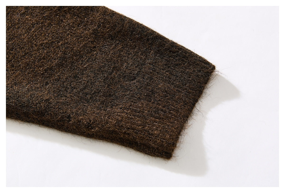 Close-up of the dark brown sweater's knit fabric and finished edge.