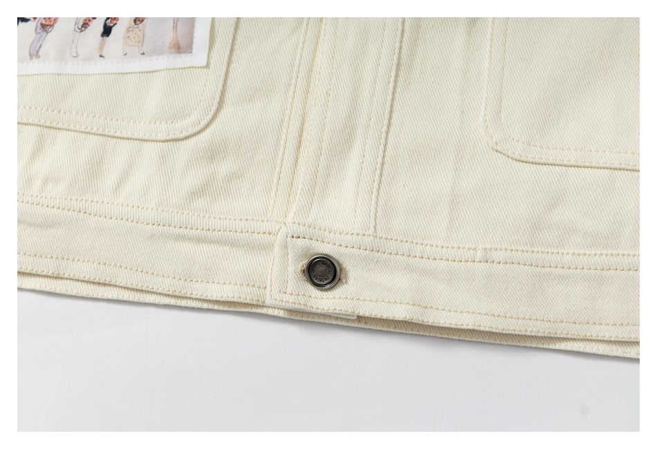 Close-up of the cream jacket hem, stitching, pocket edges, and a dark metal button.