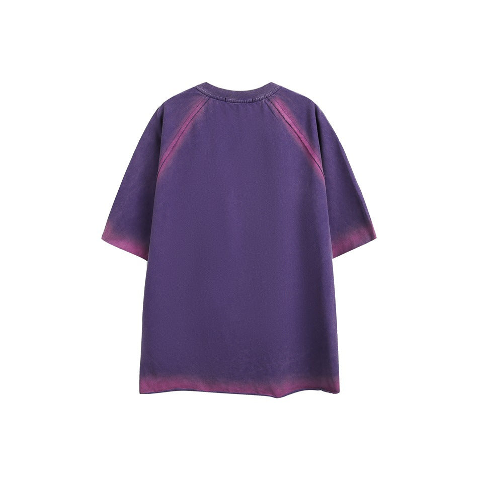 Back of a purple oversized short-sleeve raglan shirt with pink fading along the seams, sleeves and hem.